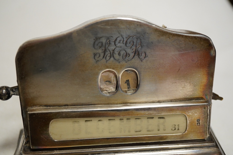 An Edwardian silver perpetual desk calendar, Birmingham, 1907, E F Braham, initalled, (mechanism a/f) together with an engine turned propelling pencil and a Swiss open faced poclet watch contained within a silver faced l